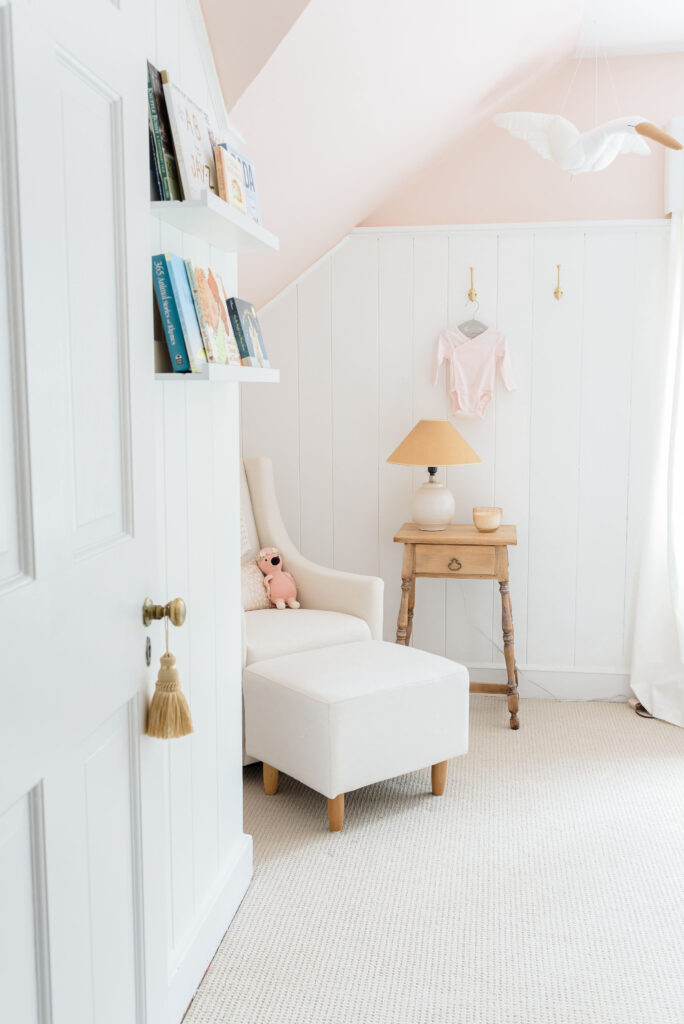 traditional pink baby girl nursery with reading nook